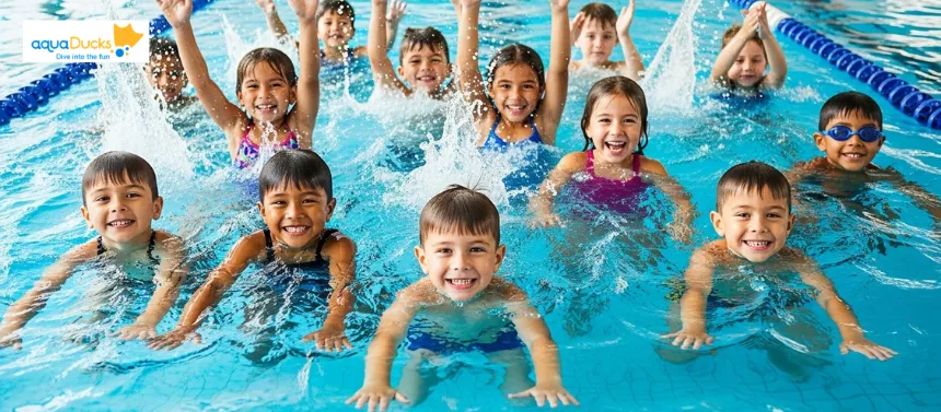 A diverse group of young children happily participating in a guided swimming lesson in an indoor pool.