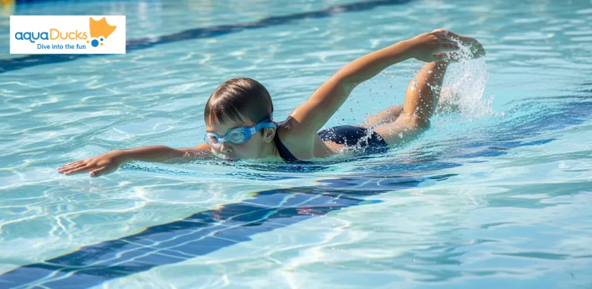 Child demonstrating correct freestyle arm stroke in swimming pool