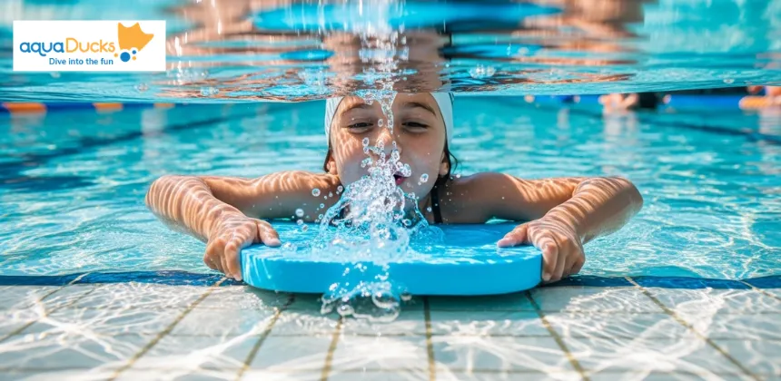 Child practising water confidence by blowing bubbles in pool