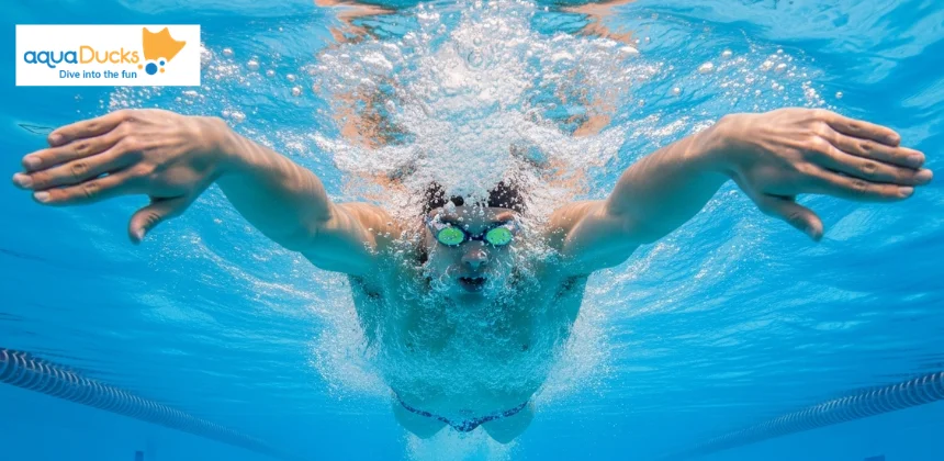 Close-up of swimmer's hands performing the wide circular sweep of breaststroke arm pull in pool water