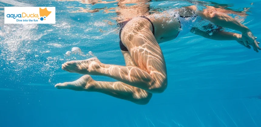 Close-up of swimmer legs performing frog kick with outward feet and snap motion