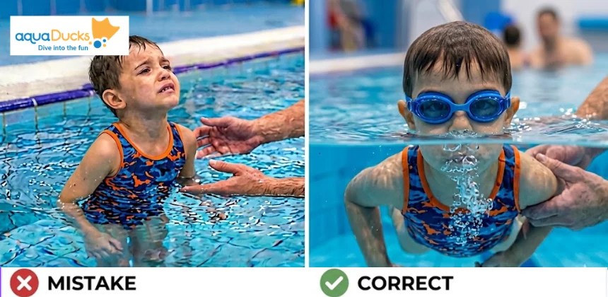 A child learning to overcome fear by blowing bubbles underwater during a swimming lesson for kids