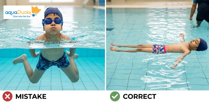 A young child practicing floating in the pool to develop balance and relaxation skills during a swimming lesson