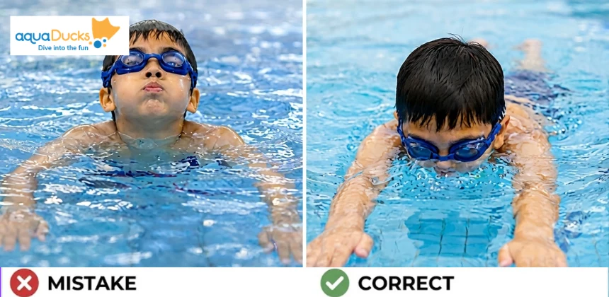 A young swimmer learning to exhale properly underwater instead of holding their breath during swimming lessons