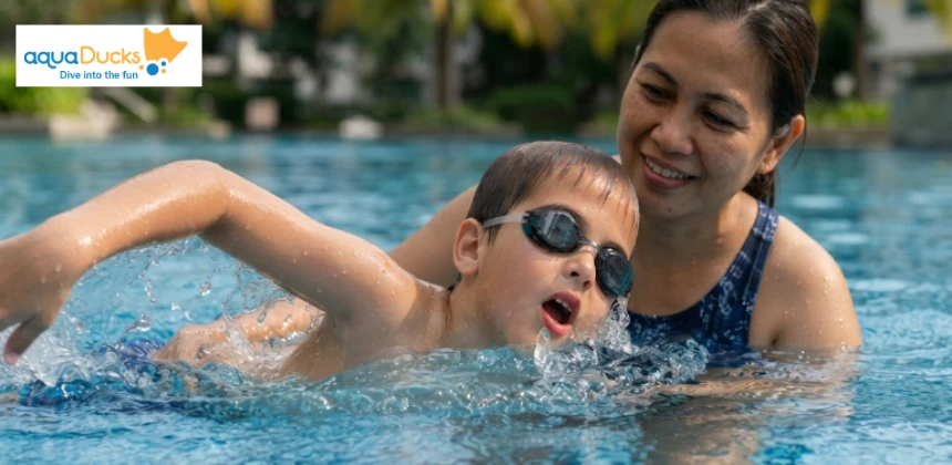 A young child practicing proper swimming breathing technique by turning their head to the side while swimming in a pool with a parent.