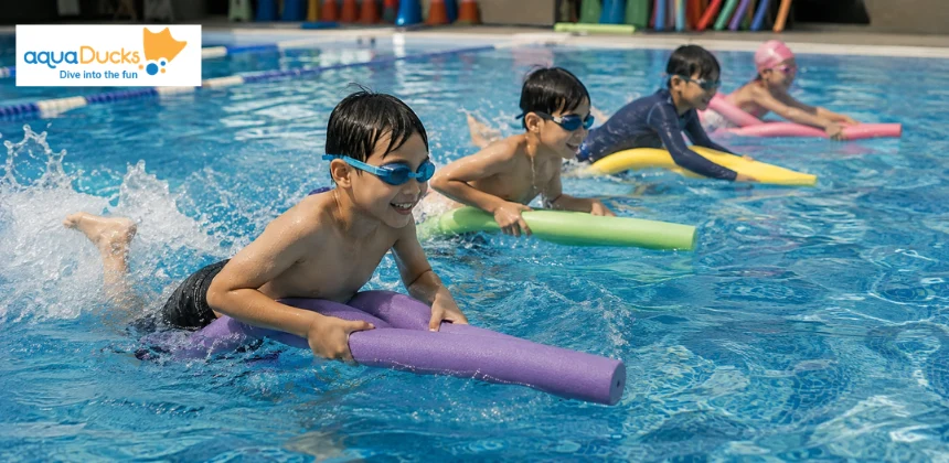 Kids racing on noodles during exciting swimming race games, enjoying fun swimming games for kids and pool activities together.