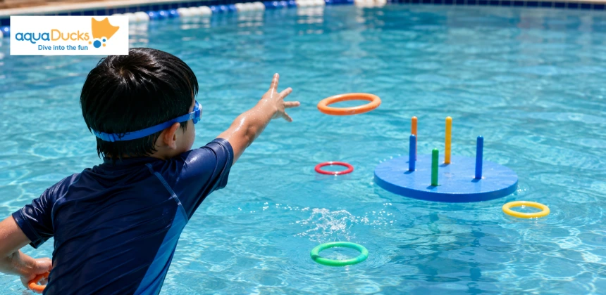 Child enjoying swimming games for kids with a ring toss target, trying engaging games to play in swimming pool during lessons.