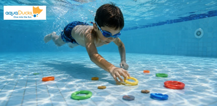 Child diving underwater for toys, enjoying swimming games for kids and exploring fun swimming pool water games during practice.