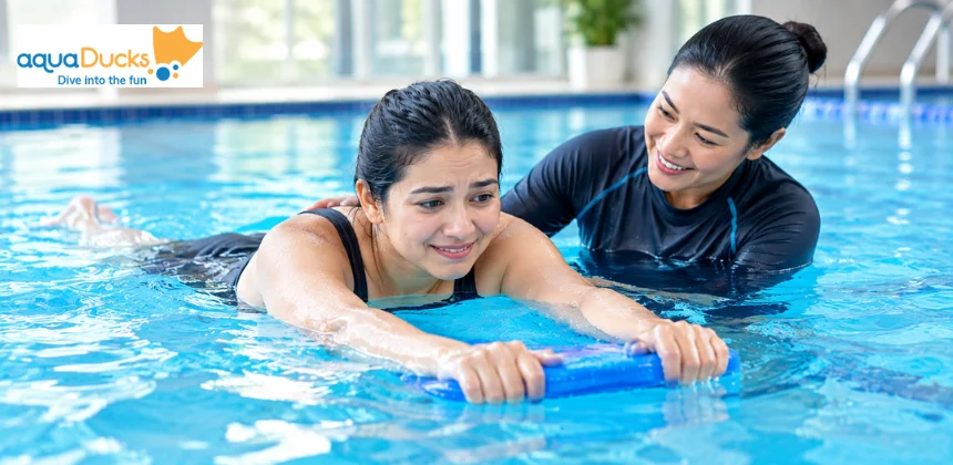 Nervous adult learning to swim with support from an instructor