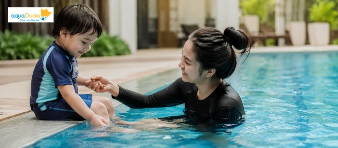 A mother helping her son at the pool to help your child overcome their fear of water and feel safe in the water.